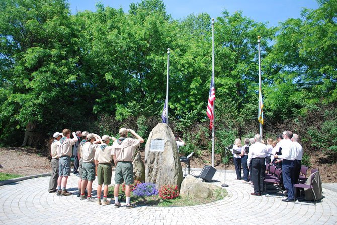 Boy Scout Troop 55 and the Great Falls United Methodist Church choir stand to say the Pledge of Allegiance at the Great Falls Freedom Memorial Monday, May 26.